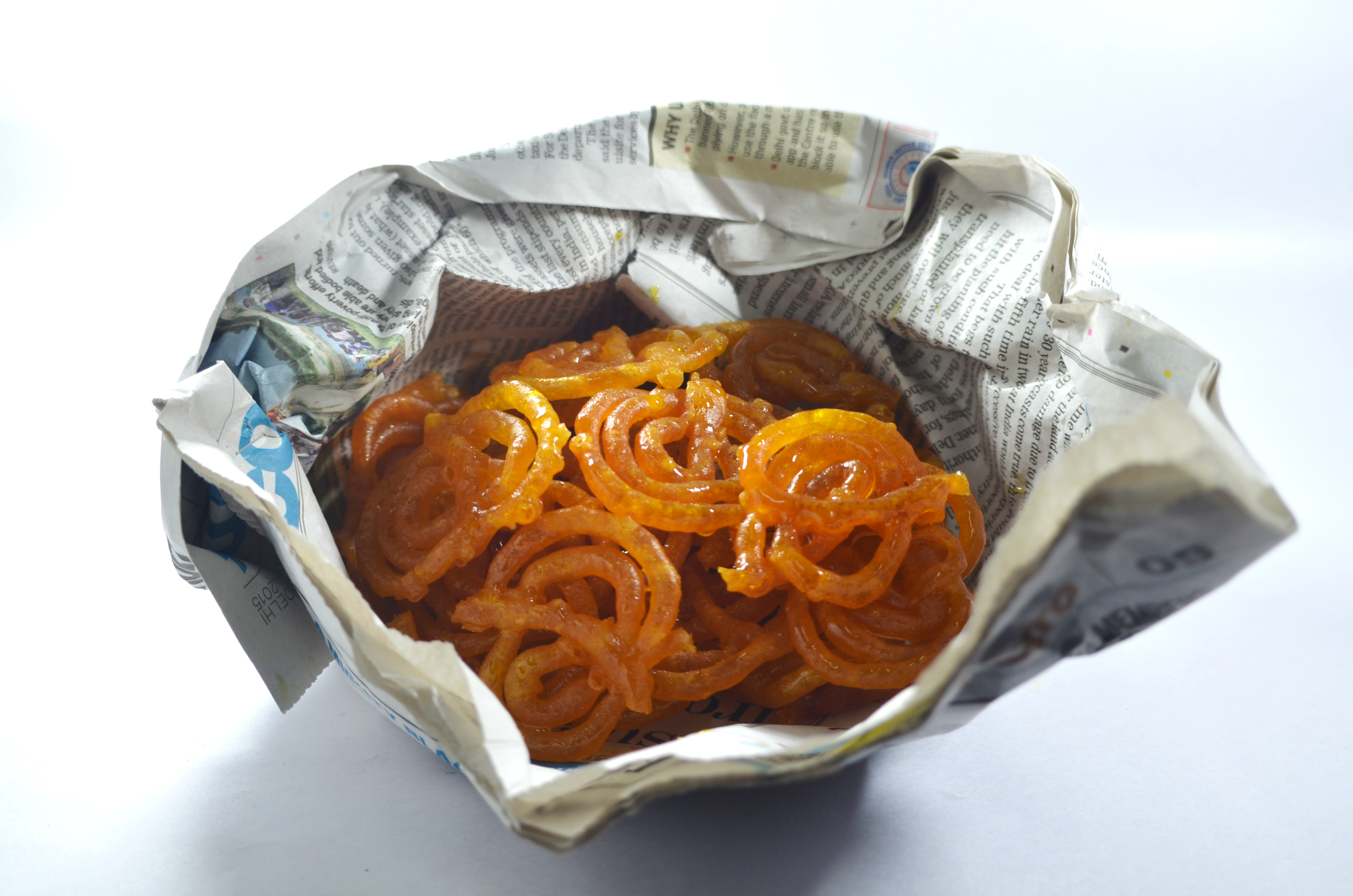 Real photograph of authentic hot street food served on traditional paper parcel